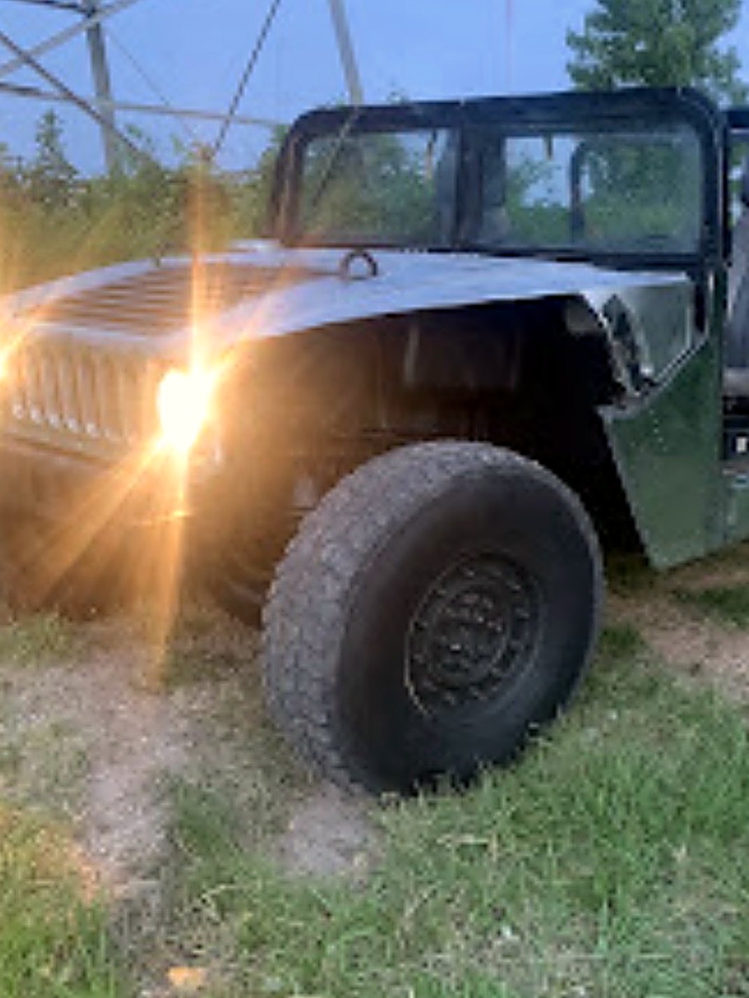 LuxeHaus build at dusk, headlights on — bare-metal riveted bodywork