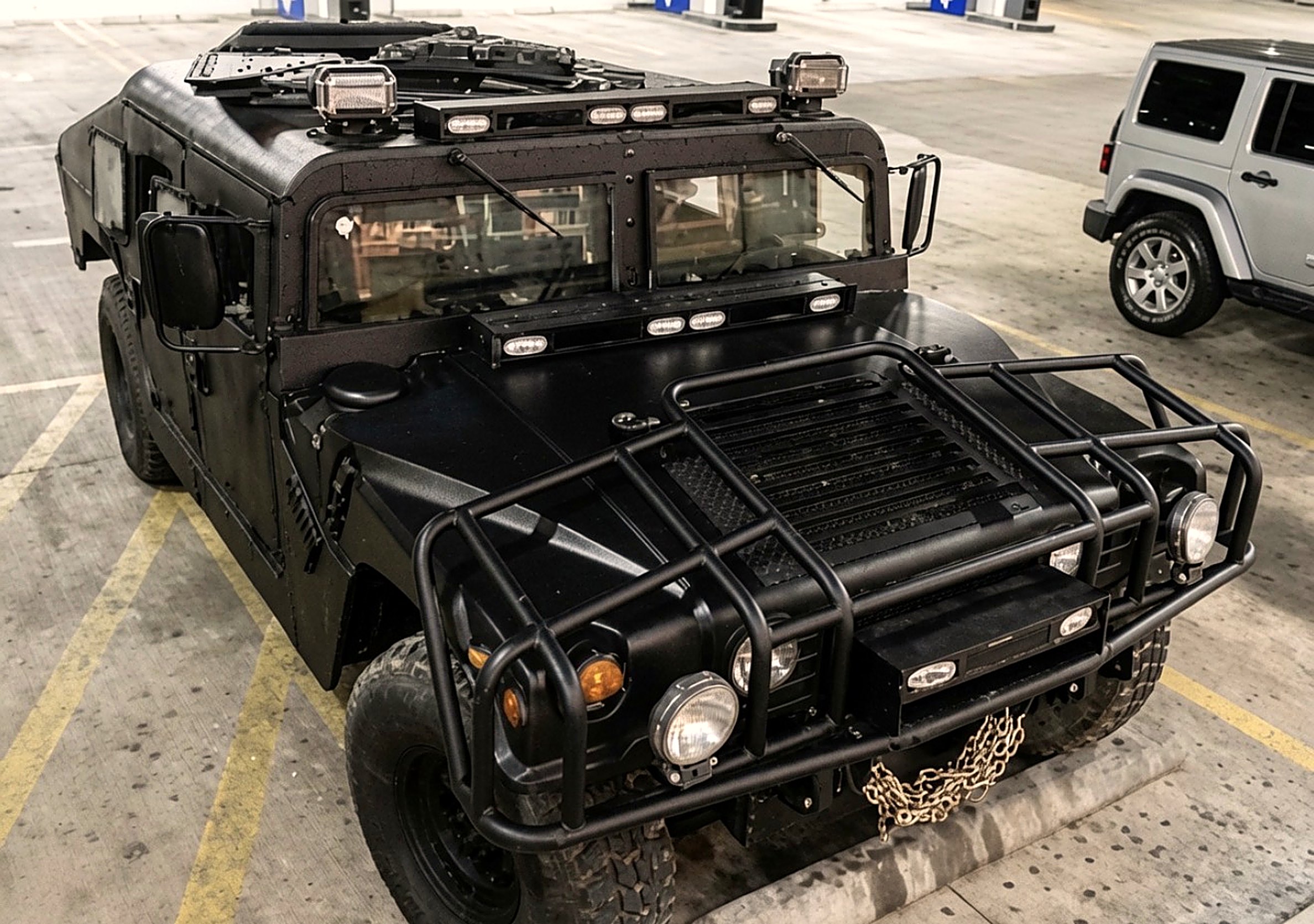 LuxeHaus Obsidian Series HMMWV — hood rack, light bars, and winch chain
